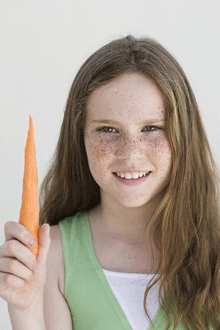 girl holding a carrot