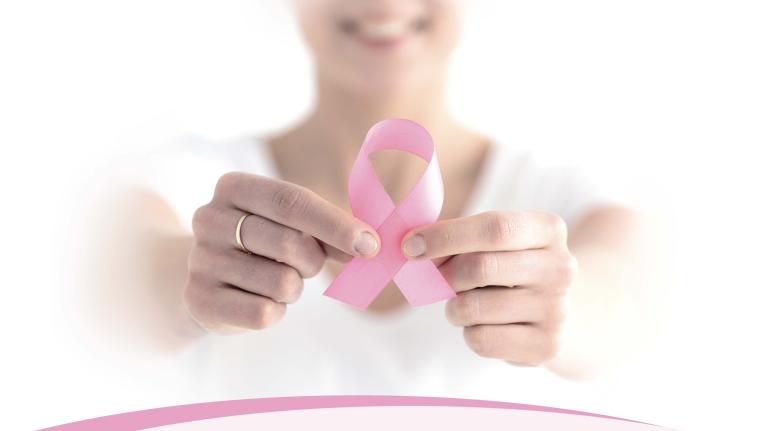 woman holding a pink ribbon woman holding a pink ribbon