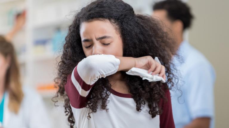 student coughing in a classroom student coughing in a classroom